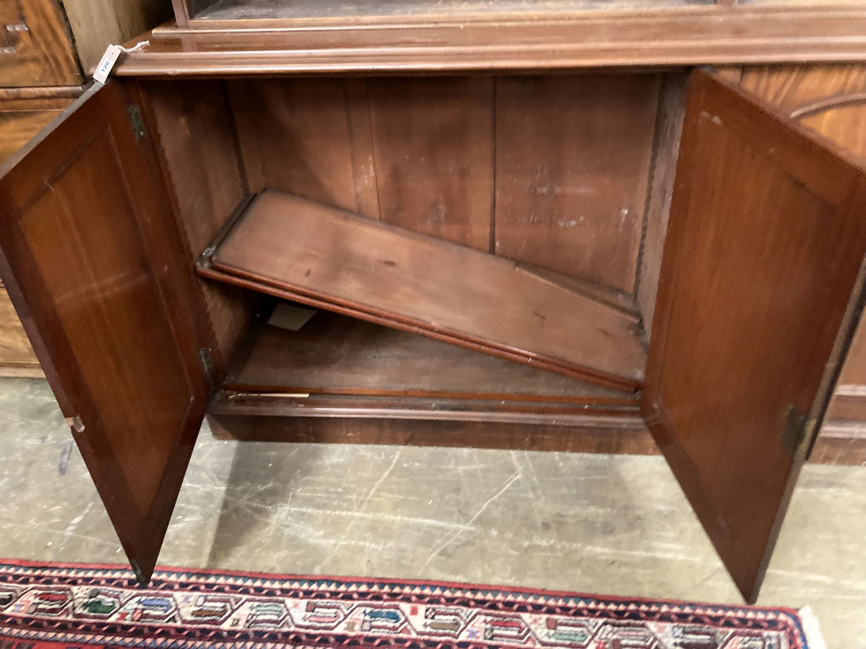 A Victorian mahogany library bookcase, the open shelves over an enclosed four door base, length 230cm, depth 50cm, height 238cm